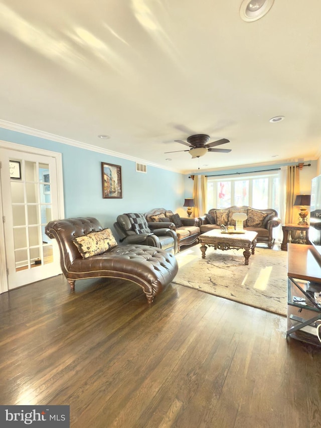 living room with crown molding, ceiling fan, and dark hardwood / wood-style flooring