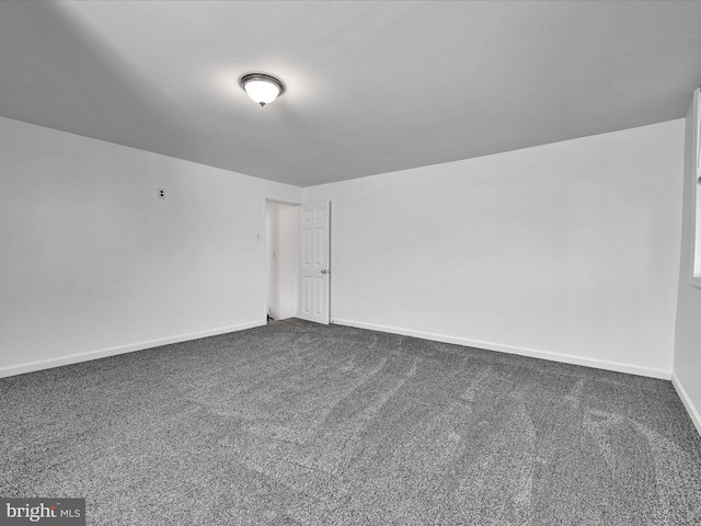 empty room with dark colored carpet