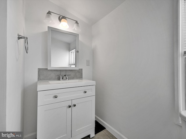 bathroom featuring lofted ceiling and vanity