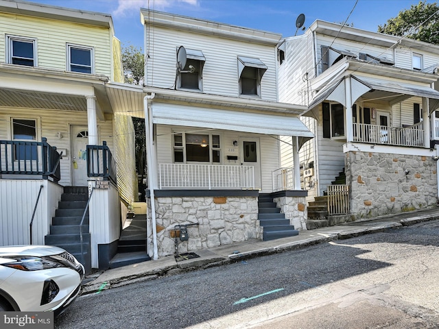 townhome / multi-family property featuring covered porch