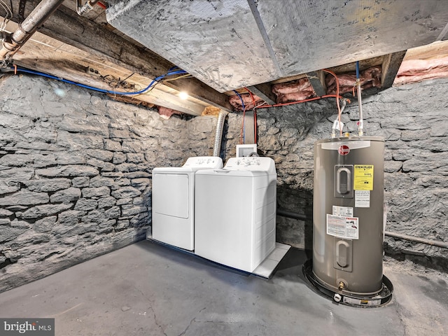 basement with electric water heater and separate washer and dryer