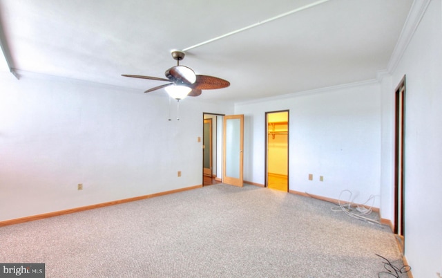 unfurnished room with carpet flooring, ceiling fan, and crown molding