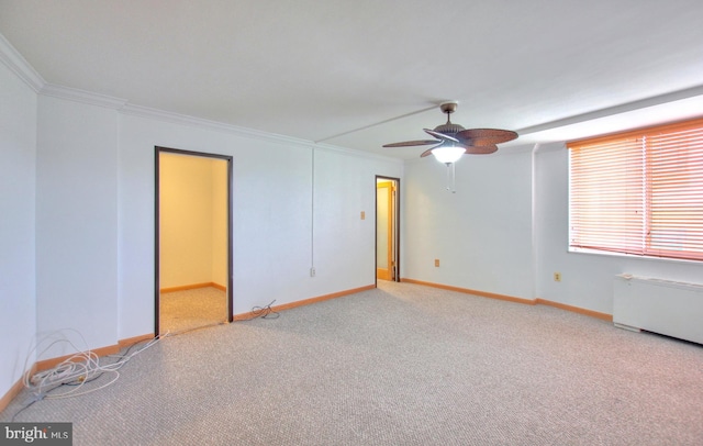 carpeted empty room featuring ceiling fan, radiator, and ornamental molding