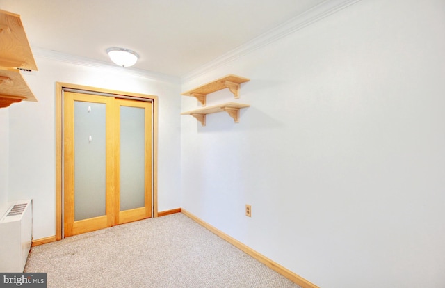 interior space featuring ornamental molding, radiator, and carpet floors