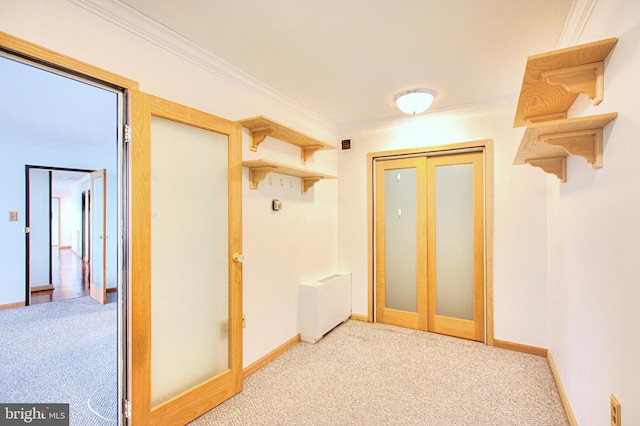 hall with crown molding and light carpet