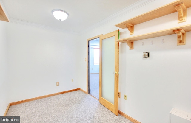 interior space featuring crown molding and light carpet