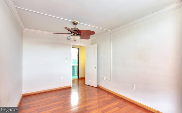 unfurnished room with crown molding, ceiling fan, and wood-type flooring