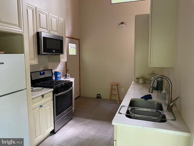 kitchen featuring a wealth of natural light, stainless steel appliances, and sink