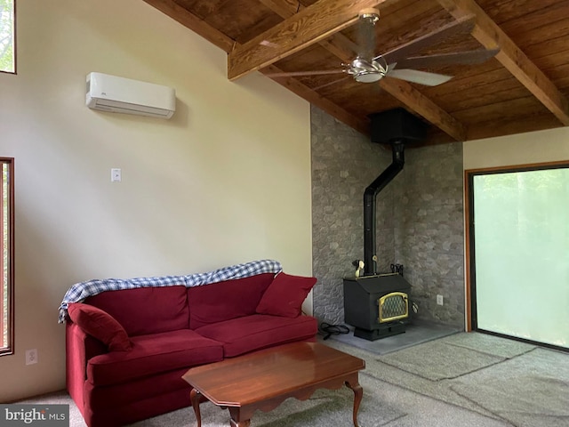 living room with a wall unit AC, wooden ceiling, a wood stove, carpet, and ceiling fan