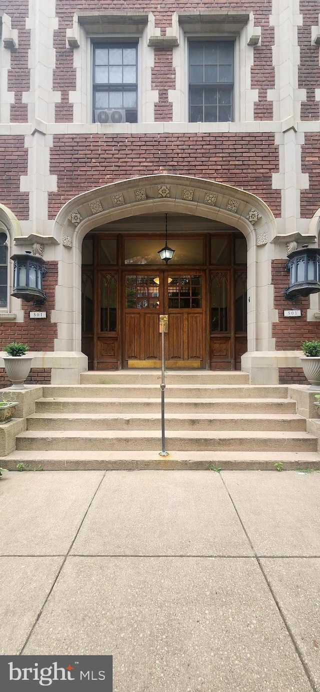 property entrance featuring brick siding