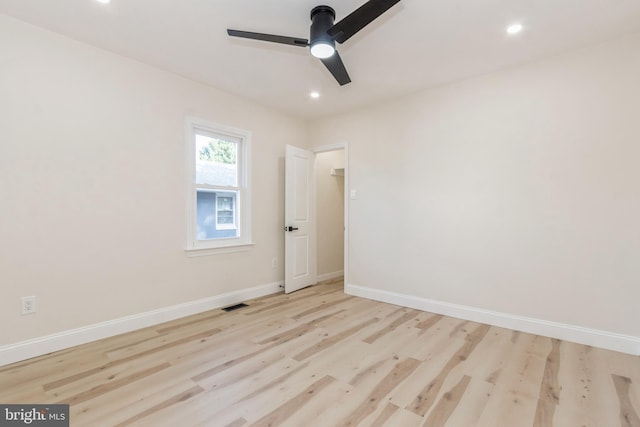 empty room with light hardwood / wood-style floors and ceiling fan