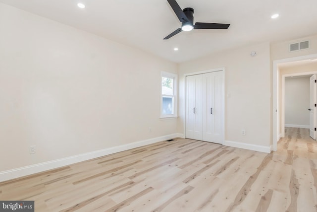 unfurnished bedroom featuring ceiling fan, a closet, and light hardwood / wood-style floors