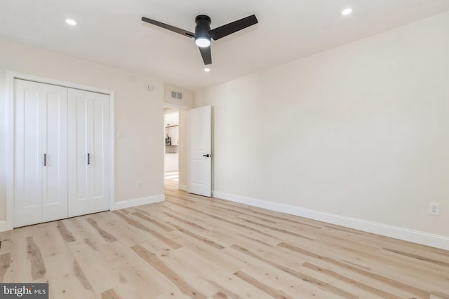 unfurnished bedroom featuring a closet, light wood-type flooring, and ceiling fan