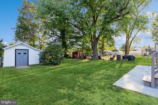 view of yard with a shed and a patio