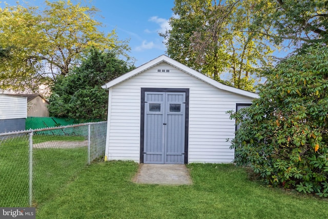 view of outdoor structure with a lawn