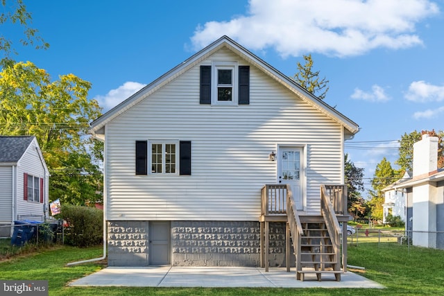 rear view of property with a yard