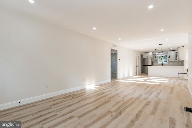 unfurnished living room featuring light wood-type flooring