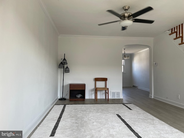 spare room with ornamental molding, wood-type flooring, and ceiling fan