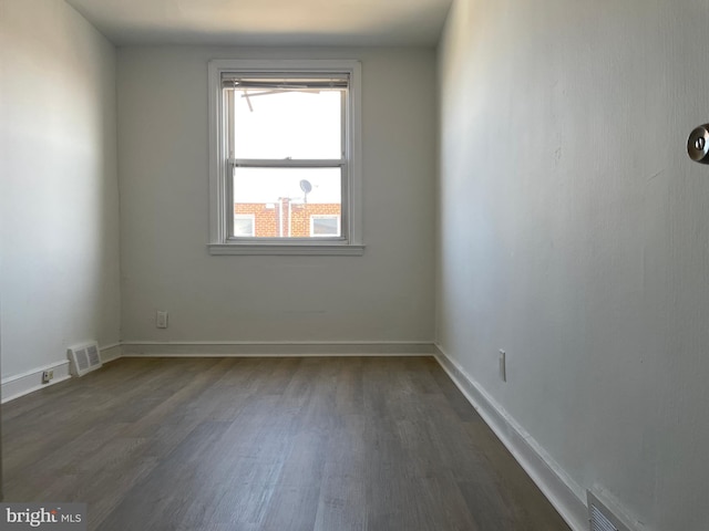 spare room with dark hardwood / wood-style flooring