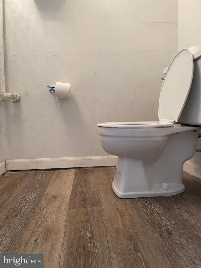 bathroom with toilet and hardwood / wood-style floors