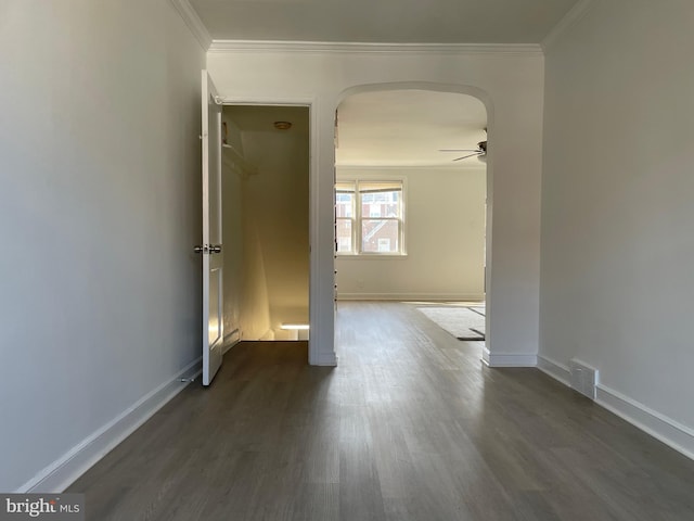 spare room with ornamental molding, ceiling fan, and dark hardwood / wood-style floors