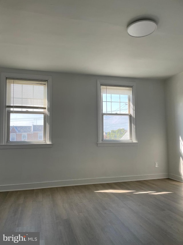 spare room with dark wood-type flooring