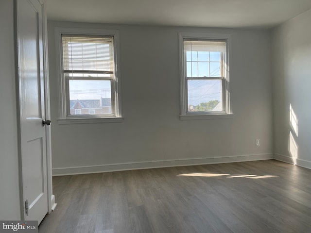 empty room featuring dark hardwood / wood-style floors and a healthy amount of sunlight