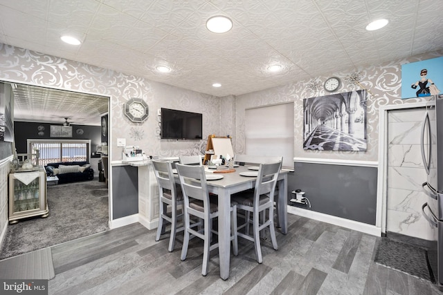 dining area featuring hardwood / wood-style flooring and ceiling fan