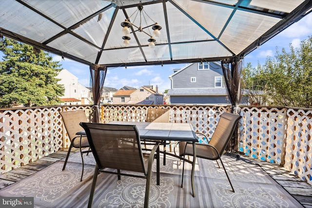 deck featuring a gazebo and outdoor dining area