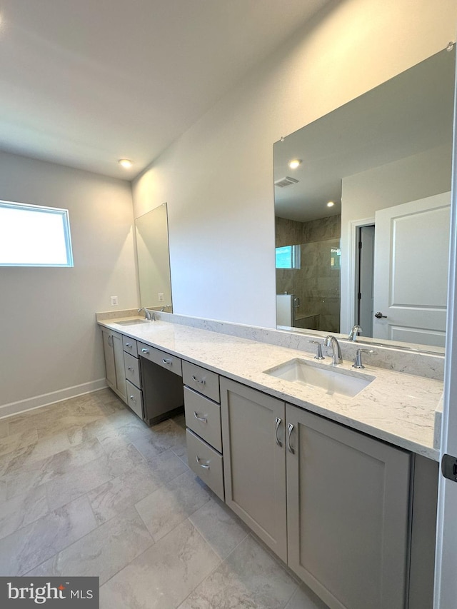 full bathroom with double vanity, visible vents, a stall shower, and a sink