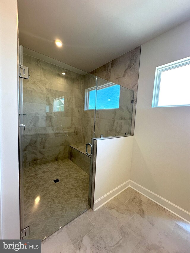 bathroom featuring recessed lighting, baseboards, and a stall shower