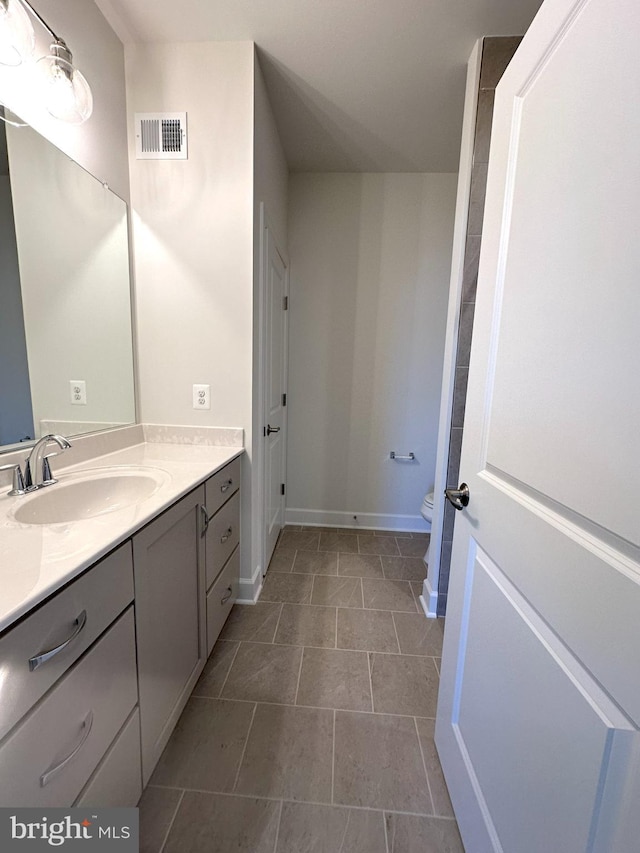 bathroom with visible vents, toilet, tile patterned flooring, baseboards, and vanity