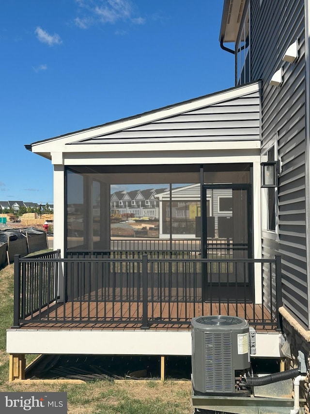 deck with a sunroom and cooling unit