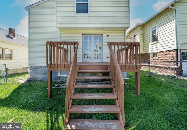 back of house featuring stairway, a lawn, a deck, and fence