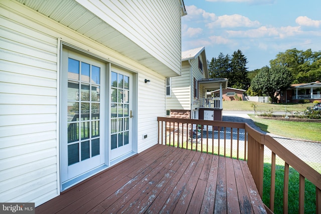 wooden terrace with a yard