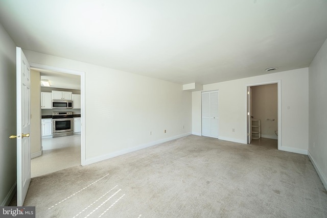 unfurnished bedroom featuring light colored carpet