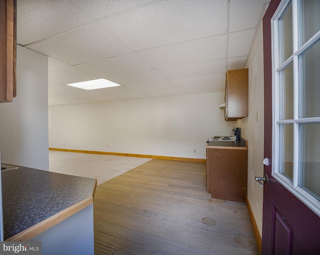 interior space featuring hardwood / wood-style flooring and a drop ceiling