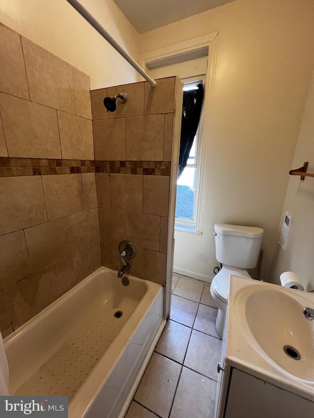 full bathroom featuring tiled shower / bath combo, tile patterned flooring, vanity, and toilet