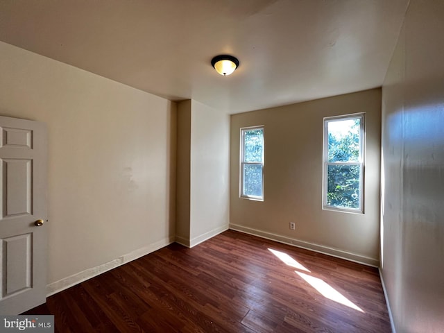 spare room featuring dark hardwood / wood-style floors