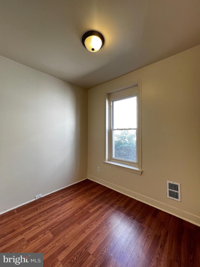 empty room with wood-type flooring