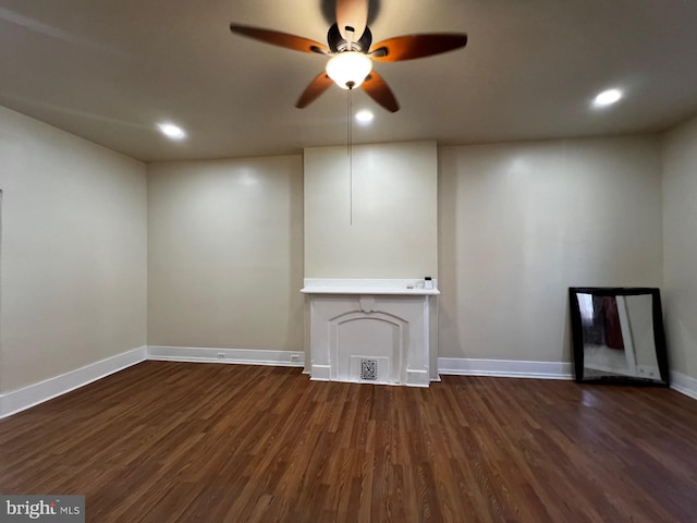 unfurnished living room featuring dark hardwood / wood-style floors and ceiling fan