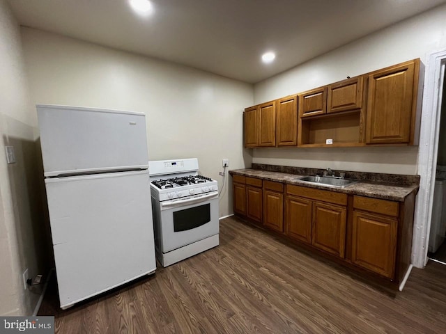 kitchen featuring dark hardwood / wood-style floors, sink, and white appliances