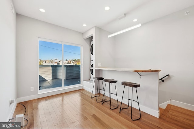 bar with light hardwood / wood-style flooring