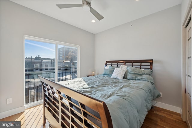 bedroom with hardwood / wood-style floors, ceiling fan, and access to exterior