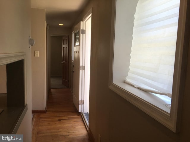 corridor with recessed lighting, baseboards, and wood finished floors