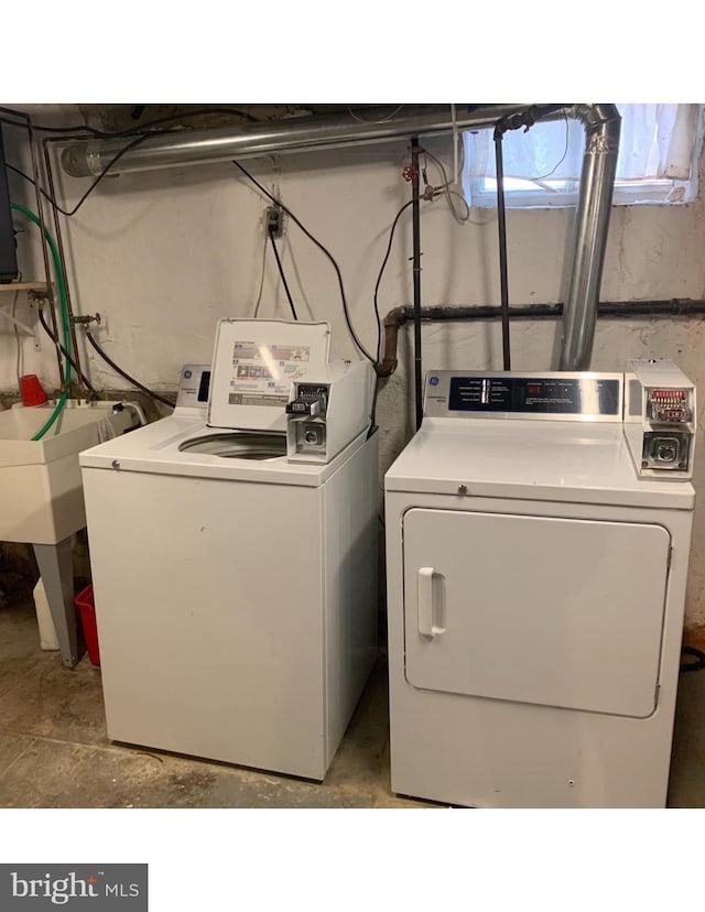 laundry room featuring a sink, laundry area, and washer and clothes dryer