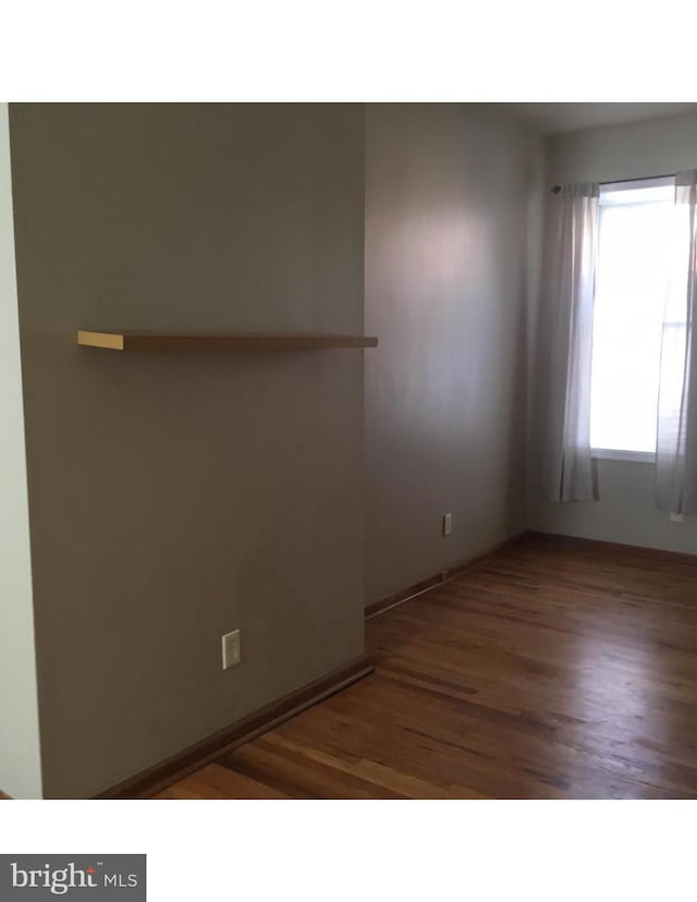 empty room with wood finished floors