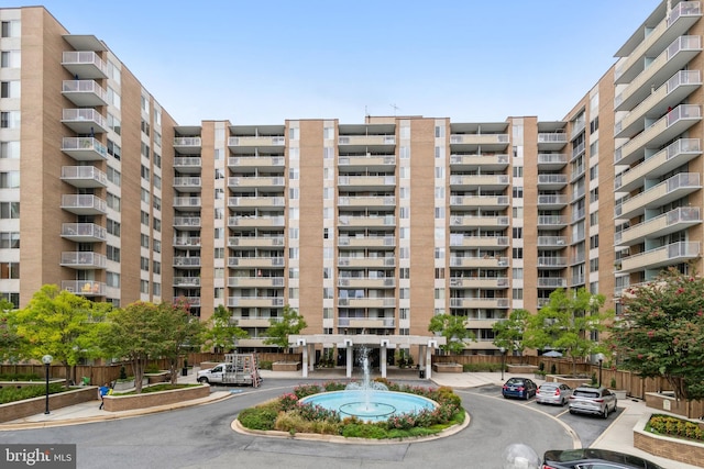 view of building exterior featuring uncovered parking