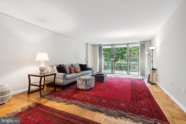 living room featuring a wall of windows and light parquet flooring