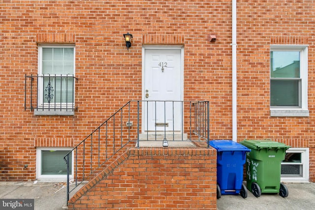 view of exterior entry with brick siding